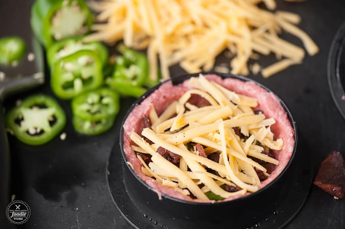 raw burger patty with cheese bacon and jalapeno inside