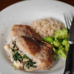 stuffed pork chop on plate with broccoli and rice