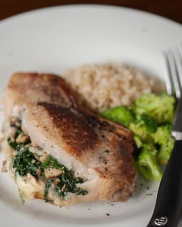 Stuffed Pork Chops with bone in pork chops, spinach, mushrooms, and provolone make for a moist and delicious weeknight family dinner.