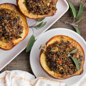 four roasted acorn squash halves stuffed with sausage and rice filling