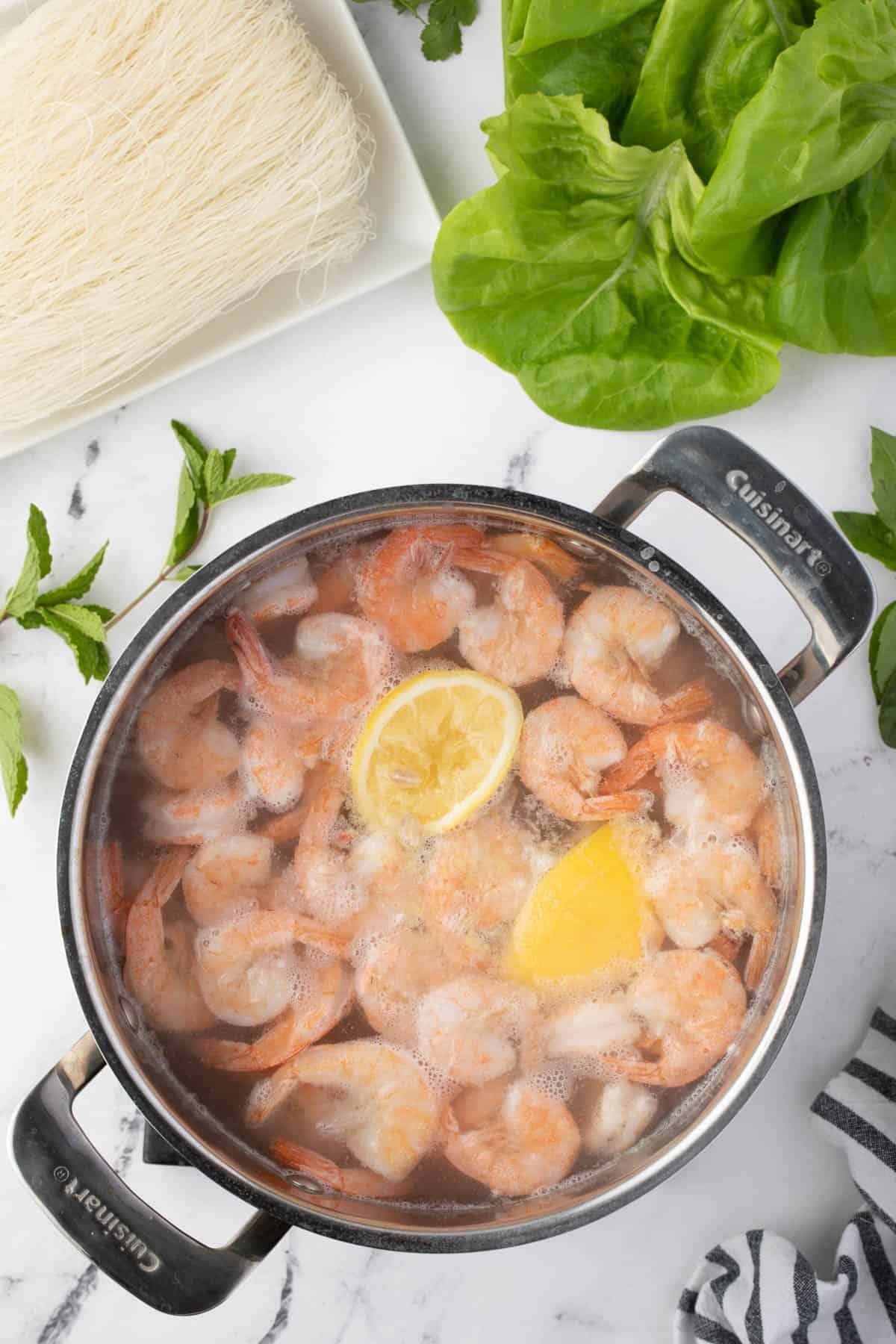 poaching shrimp in boiling water with lemon.