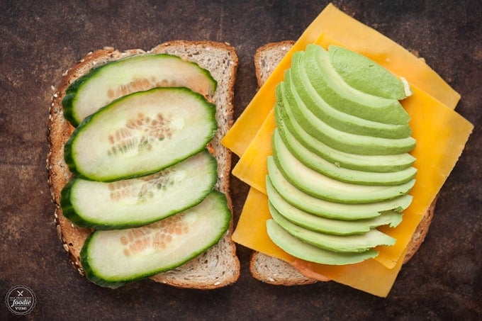 cucumbers, avocado, and cheese on bread