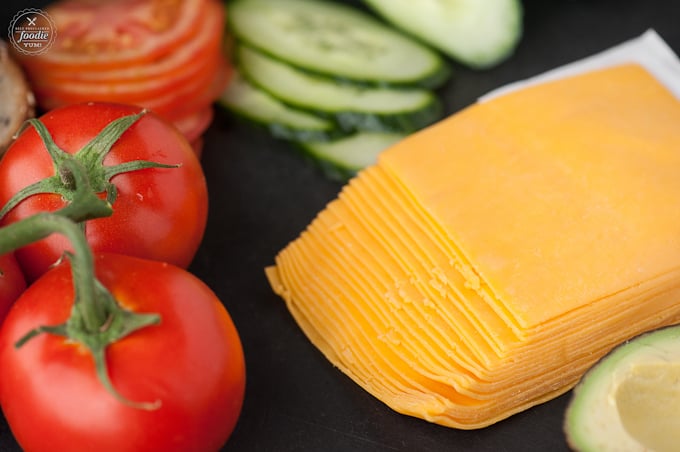 a close up of cheese, cucumbers, and tomatoes