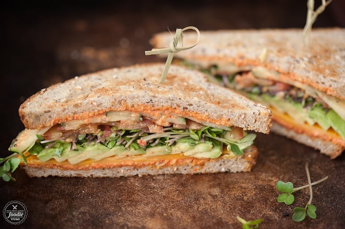 A summer veggie sandwich cut in half