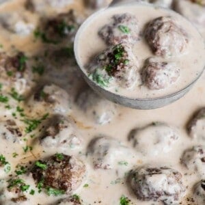 Ladel full of homemade swedish meatballs in sauce