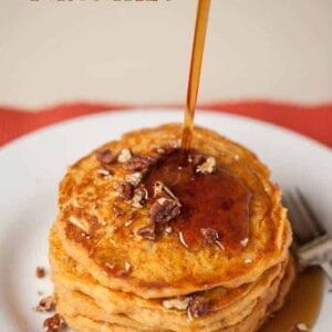 sweet potato pancakes with syrup being poured onto it