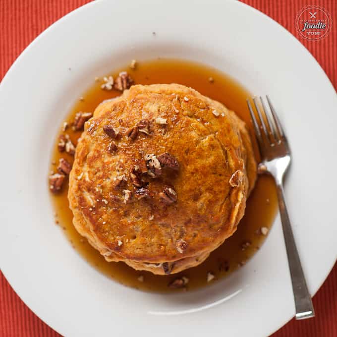 sweet potato pancakes on a white plate with syrup
