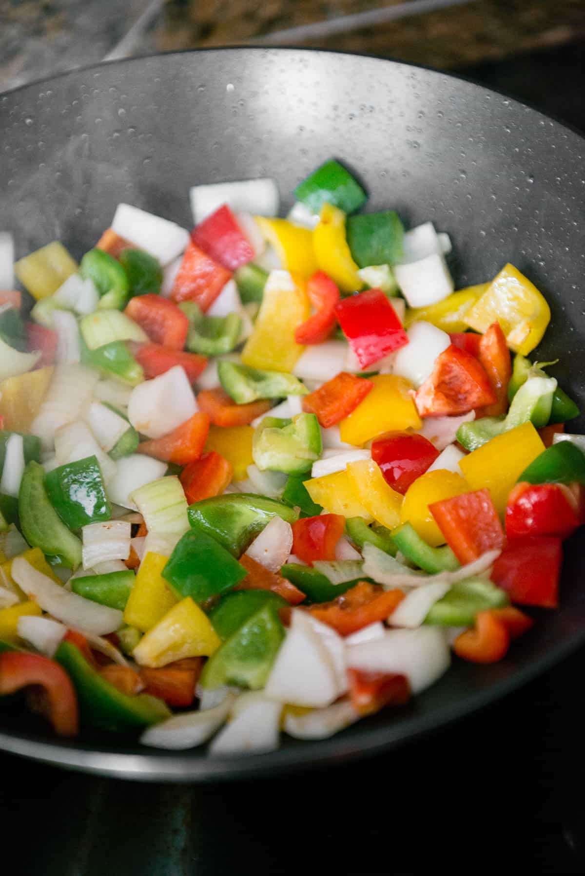 raw peppers and onions in pan