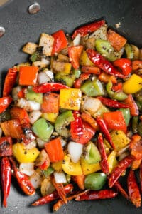 sauteed peppers and onions in wok pan