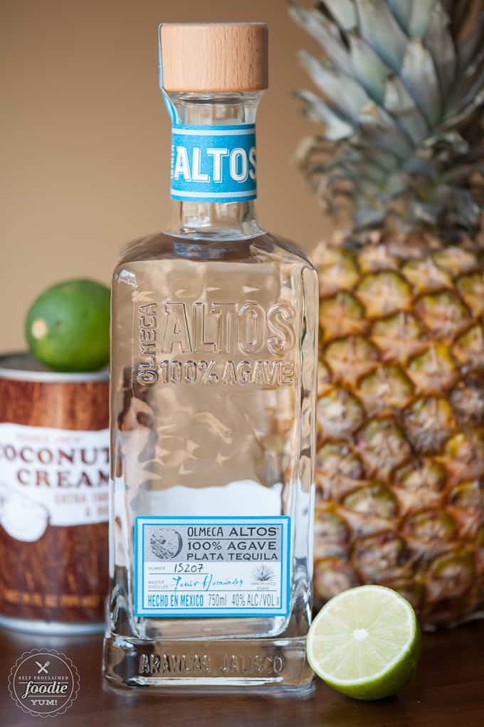silver tequila with pineapple, can of coconut cream, and lime