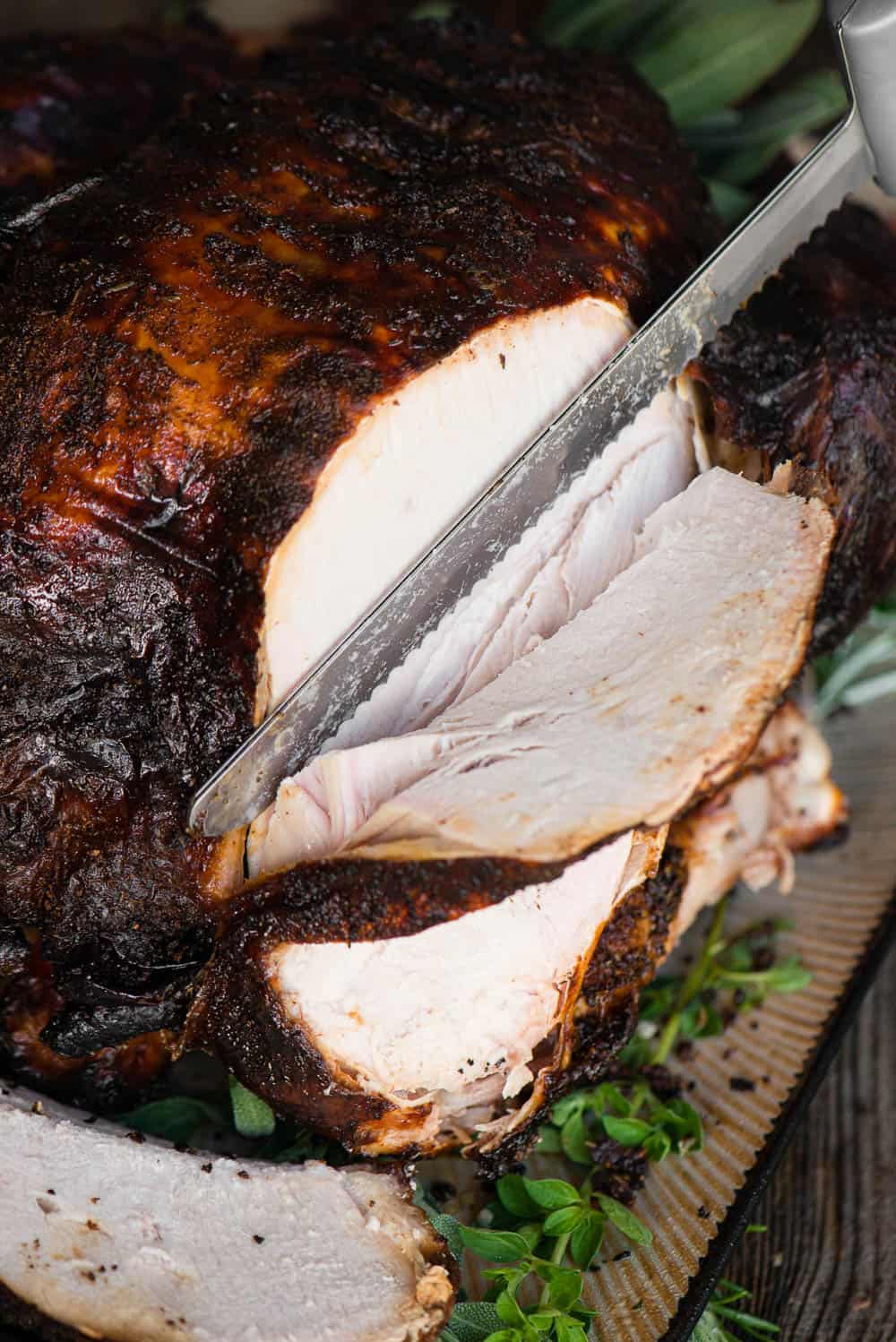 slicing a whole turkey with an electric knife