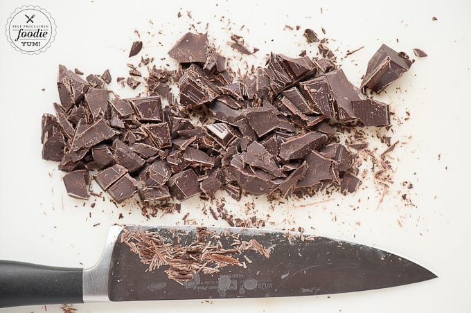 chopped chocolate on white cutting board