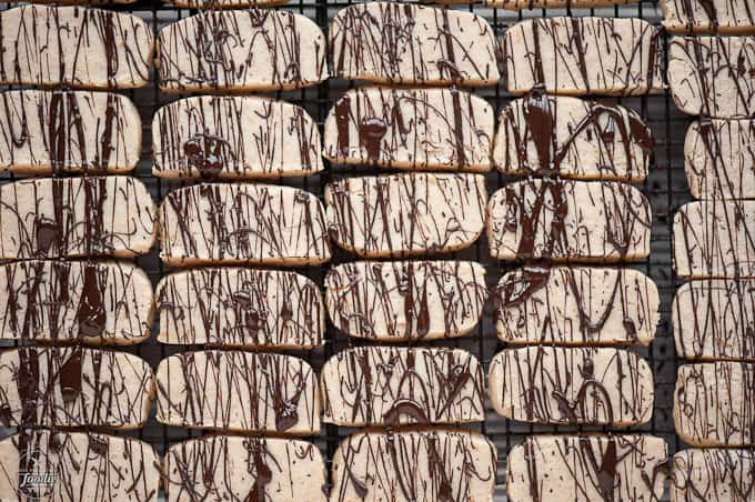 looking down at coconut shortbread cookies with a melted chocolate drizzle