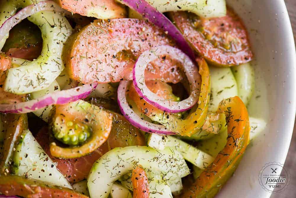 homemade marinated tomato cucumber salad with red onions and garden grown tomatoes and cucumber