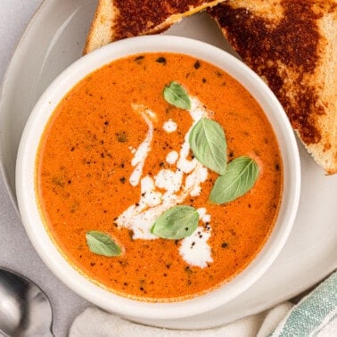 tomato soup from pasta sauce with heavy cream and basil garnish with sliced grilled cheese on the side.