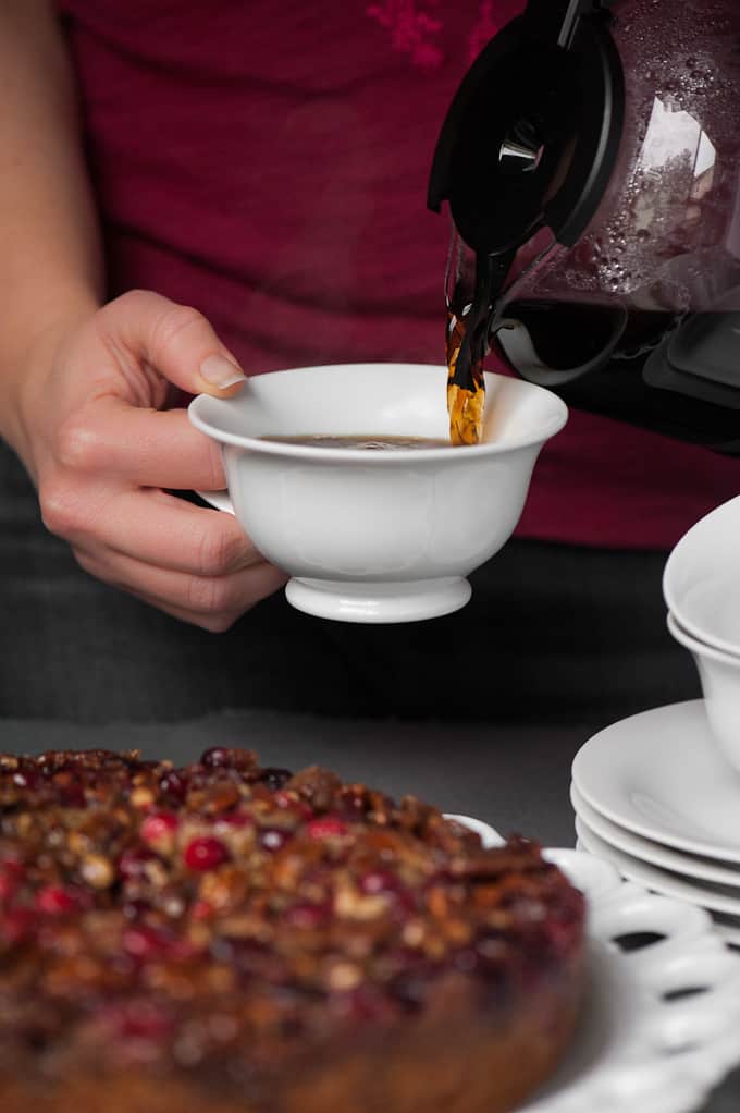 pouring cup of coffee in front of homemade cake