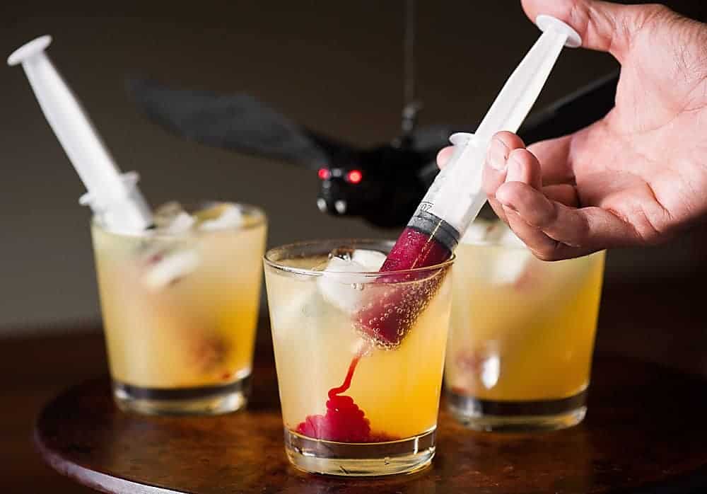 Vampire Cocktail is the perfect spooky Halloween drink. Syringes filled with sweetened raspberry puree look gory, but taste amazing!