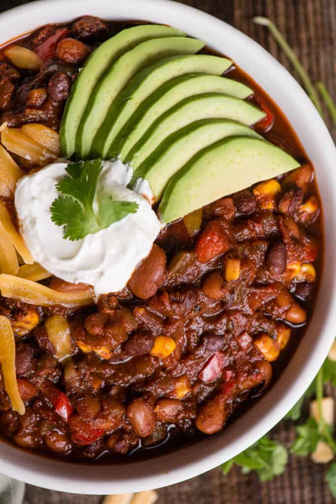 close up of a bowl of homemade vegetarian chili with toppings