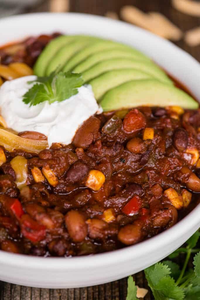 bowl of chili with avocado and sour cream