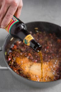 pouring beer into vegetarian chili recipe