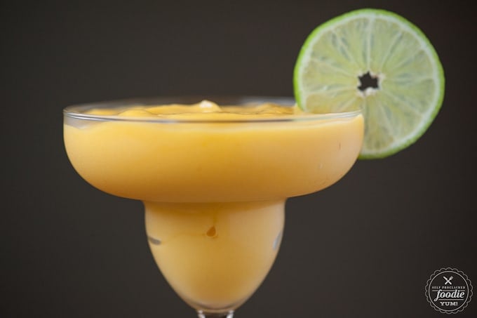 Virgin Mango Lime Margarita in glass with lime garnish