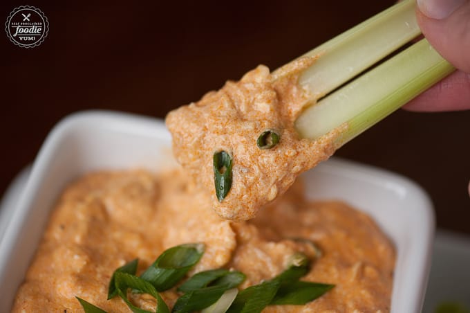 cheesy chicken dip with buffalo sauce on celery