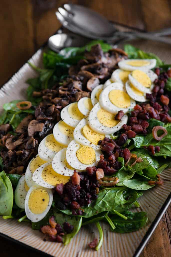 Warm Spinach Salad with egg, bacon, and mushrooms