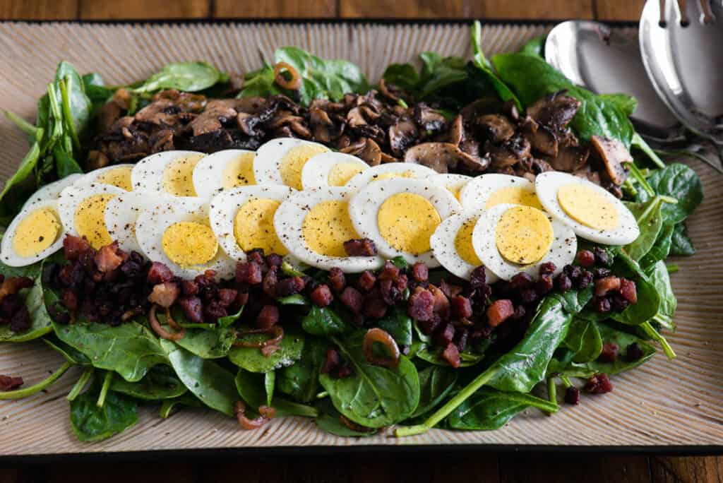 platter with Warm Spinach Salad with hard boiled egg