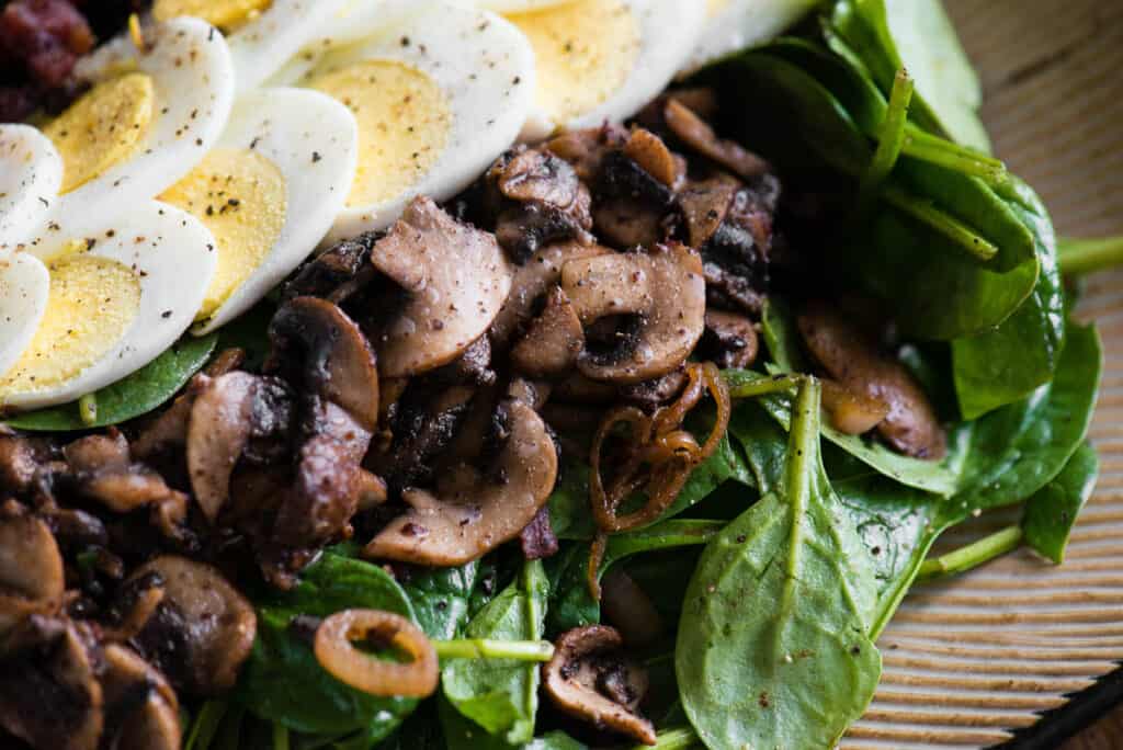 sautéed mushrooms on warm spinach salad
