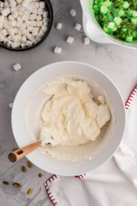 Whipping heavy cream and softened cream cheese together.