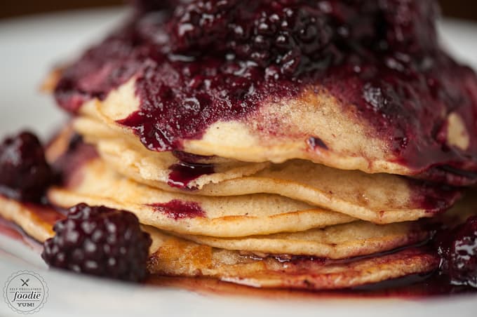 A close up of food on a plate, with Pancake and Berry