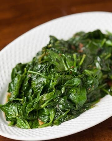 Hot and flavorful Wilted Garlic Spinach is an easy and healthy side dish that compliments any dinner, and the best part is that it takes minutes to prepare.