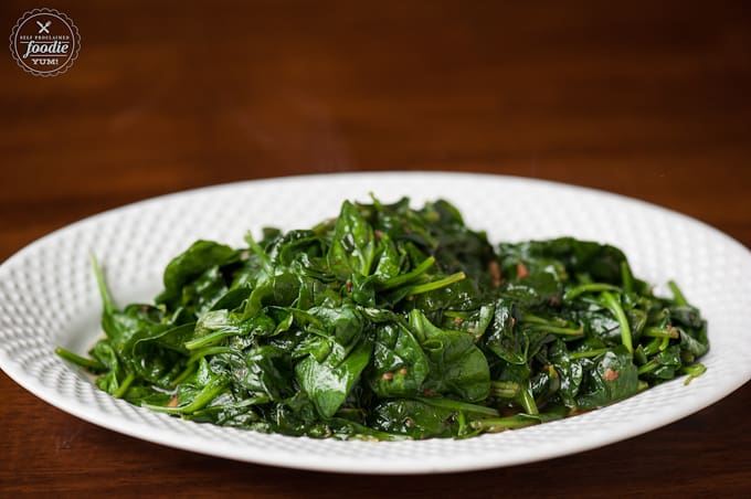 wilted spinach with garlic on white dish