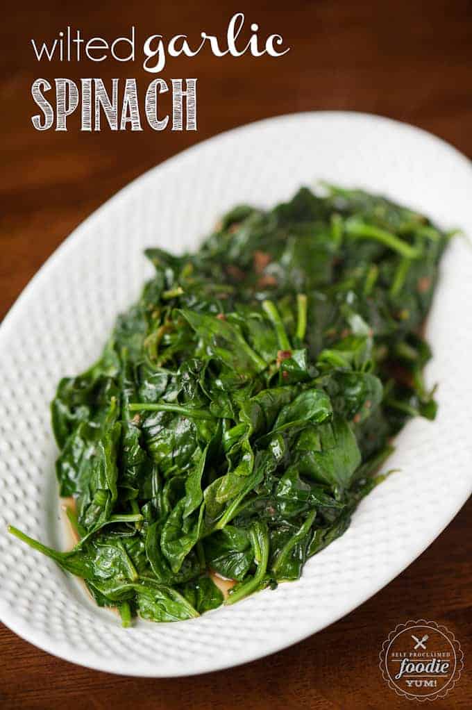 steamed garlic spinach on white plate