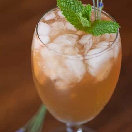 Transform your relaxing chamomile tea into this Wind Down Spa Iced Tea by infusing the vibrant flavors of lavender, sage, peppermint, and cloves.