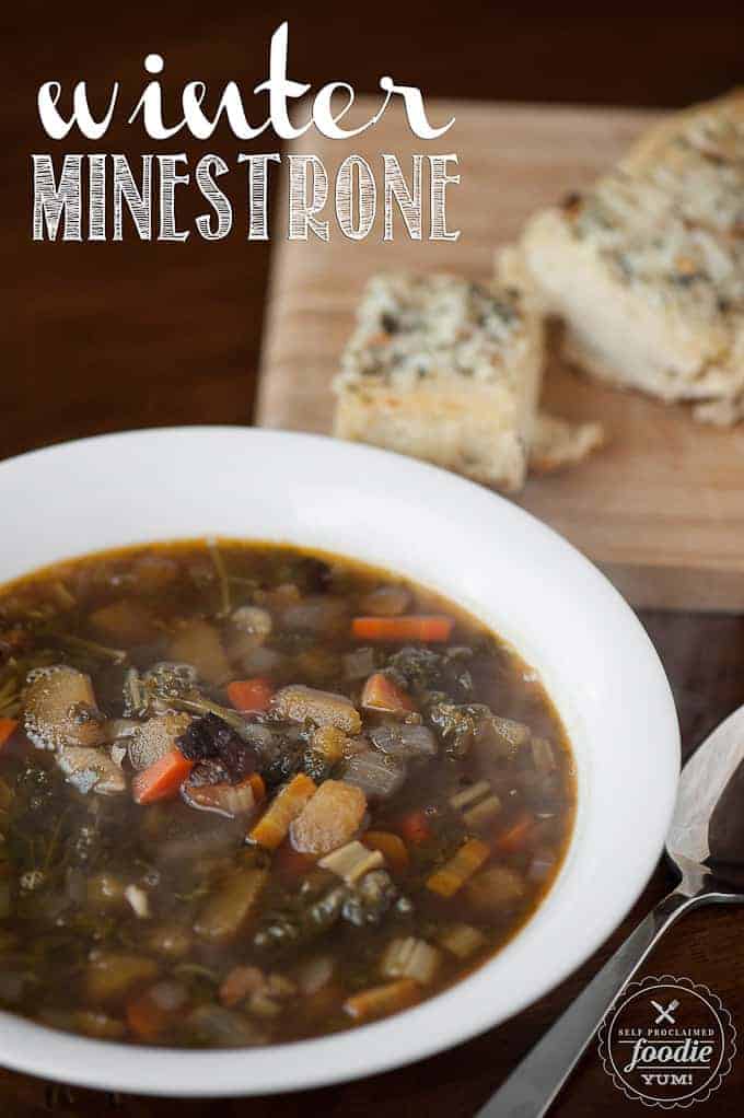 bowl of minestrone soup with bread on side